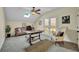 Bright home office with a ceiling fan, skylight, desk, and balcony access through glass paneled french doors at 210 Torcaso Ct, Winter Springs, FL 32708