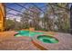 Screened-in pool and spa with brick surround offers a relaxing outdoor retreat with mature trees at 210 Torcaso Ct, Winter Springs, FL 32708