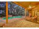 Covered patio with lounge chairs overlooks a screened pool and lush backyard, perfect for entertaining at 210 Torcaso Ct, Winter Springs, FL 32708