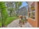 View of the pool from the patio with beautiful foliage and a tranquil setting at 210 Torcaso Ct, Winter Springs, FL 32708