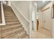 Carpeted staircase with white railing leading to the upper level of the house at 210 Torcaso Ct, Winter Springs, FL 32708