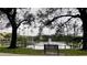 View of community pond with fountain and walking path and gazebo with apartment buildings in the background at 2200 Metropolitan Way # 926, Orlando, FL 32839