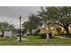 View of community sign for Charles Towne with a street view and shopfronts at 2200 Metropolitan Way # 926, Orlando, FL 32839