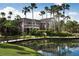 Scenic view of a well-maintained building near a pond and lush greenery with a bridge at 2200 Metropolitan Way # 926, Orlando, FL 32839