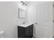 Bathroom featuring a vanity with sink and mirror, next to a doorway at 2206 W Pine St, Orlando, FL 32805