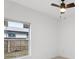 Bedroom featuring a ceiling fan and a window overlooking the yard at 2206 W Pine St, Orlando, FL 32805