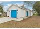 Charming home featuring a blue garage door and a well-maintained front yard at 2206 W Pine St, Orlando, FL 32805