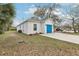 White home featuring a blue garage door and a well-maintained front yard at 2206 W Pine St, Orlando, FL 32805