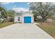 Charming home featuring a blue garage door and a well-maintained front yard at 2206 W Pine St, Orlando, FL 32805