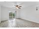 Bright living room with stylish flooring, ceiling fan, and sliding glass doors opening to the backyard at 2206 W Pine St, Orlando, FL 32805