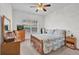 Bright bedroom features a ceiling fan, window, and a cozy, comfortable bed at 2314 Arbor Lakes Cir # 1, Sanford, FL 32771