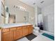 Bathroom featuring a vanity with stone countertop and a walk-in shower with white marble tile at 2336 Caravelle Cir, Kissimmee, FL 34746