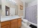 Bathroom featuring a vanity with quartz countertop and a walk-in shower with white marble tile at 2336 Caravelle Cir, Kissimmee, FL 34746