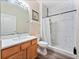 Bathroom featuring a vanity with marble countertop and a walk-in shower with white marble tile at 2336 Caravelle Cir, Kissimmee, FL 34746