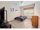 Bedroom featuring wood-look floors, neutral walls, and a window with patterned curtains at 2336 Caravelle Cir, Kissimmee, FL 34746