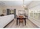 Cozy dining area with wood table and chairs, complemented by natural light from nearby windows at 2336 Caravelle Cir, Kissimmee, FL 34746