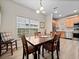 Dining area with wood table, stainless appliances and chairs near an open concept kitchen at 2336 Caravelle Cir, Kissimmee, FL 34746