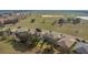 An aerial view of suburban houses with lush vegetation and a distant lake at 23431 Companero Dr, Sorrento, FL 32776