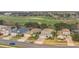 An aerial view of the neighborhood with a manicured golf course at 23431 Companero Dr, Sorrento, FL 32776