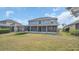 Spacious backyard featuring a screened-in porch, a trampoline, and lush green grass at 23431 Companero Dr, Sorrento, FL 32776