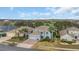 An aerial view of the blue house with a three-car garage, beautiful yard and palm trees at 23431 Companero Dr, Sorrento, FL 32776