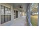 Relaxing screened porch with ceiling fans and view of a large backyard at 23431 Companero Dr, Sorrento, FL 32776