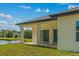 Covered back porch, view of the backyard and pond at 2875 E Slater Dr, Deltona, FL 32738