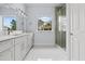 Bright bathroom featuring a double sink vanity, window, and glass-enclosed shower at 2875 E Slater Dr, Deltona, FL 32738