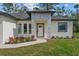 The home features stone details, a manicured lawn, and a welcoming front door at 2875 E Slater Dr, Deltona, FL 32738