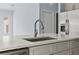 Close-up of kitchen island with quartz countertop, stainless steel sink, and modern faucet at 2875 E Slater Dr, Deltona, FL 32738