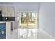 Bright kitchen area featuring sliding glass doors to the backyard and reflective marble tile flooring at 2875 E Slater Dr, Deltona, FL 32738