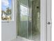 Modern glass shower with gray tile surround and a window for natural light at 2875 E Slater Dr, Deltona, FL 32738