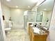 Bright bathroom featuring granite counters, tub, and glass enclosed shower at 3050 Pirates Retreat Ct # 103, Kissimmee, FL 34747