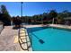 Community pool with a four foot deep end overlooking a scenic waterfront at 3050 Pirates Retreat Ct # 103, Kissimmee, FL 34747