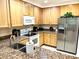 Bright kitchen featuring granite countertops, tile flooring, and modern stainless steel appliances at 3050 Pirates Retreat Ct # 103, Kissimmee, FL 34747