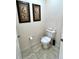 Toilet room featuring tile floors and floral wall art at 3050 Pirates Retreat Ct # 103, Kissimmee, FL 34747