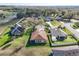 An aerial view of a three-car garage home with landscaping and a driveway at 32107 Spring Meadow Ct., Sorrento, FL 32776