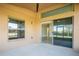 A covered back porch with sliding glass doors offering a peek inside, plus a view of the lawn and neighborhood at 32107 Spring Meadow Ct., Sorrento, FL 32776