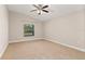 Light-filled bedroom with vaulted ceiling and neutral carpeting, ready for personalization and comfort at 32107 Spring Meadow Ct., Sorrento, FL 32776