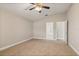 Bright bedroom with ceiling fan and two doorways to the bathroom and hallway with carpet flooring at 32107 Spring Meadow Ct., Sorrento, FL 32776