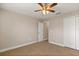 Spacious bedroom with carpet, ceiling fan, and access to a closet at 32107 Spring Meadow Ct., Sorrento, FL 32776