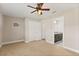 Bedroom with en-suite bathroom featuring plush carpet, ceiling fan, and a closet offering ample storage space at 32107 Spring Meadow Ct., Sorrento, FL 32776