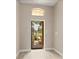 Bright foyer with an arched window over the front door and neutral tile flooring at 32107 Spring Meadow Ct., Sorrento, FL 32776