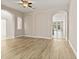 Open living room featuring hardwood floors, archways, and an abundance of natural light at 32107 Spring Meadow Ct., Sorrento, FL 32776