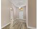 Modern living room with chandelier and archway above the front door at 32107 Spring Meadow Ct., Sorrento, FL 32776