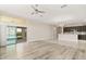 Bright open concept living room featuring hardwood floors, neutral paint, and sliding glass doors to the outside at 32107 Spring Meadow Ct., Sorrento, FL 32776