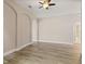 An empty living room features neutral walls, wood floors, and archways at 32107 Spring Meadow Ct., Sorrento, FL 32776