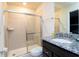 Bathroom featuring a glass enclosed tiled shower, granite countertops, and modern fixtures at 3312 Lilac Wa, Davenport, FL 33897