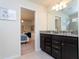 Bathroom showcasing a double sink vanity with granite counters, leading to a princess-themed bedroom at 3312 Lilac Wa, Davenport, FL 33897