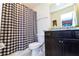 Bathroom featuring modern toilet and vanity with black and white checkered shower curtain at 3312 Lilac Wa, Davenport, FL 33897